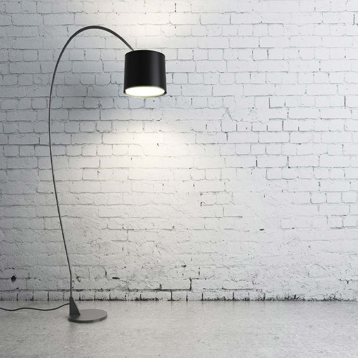 A black lamp in front of white wall